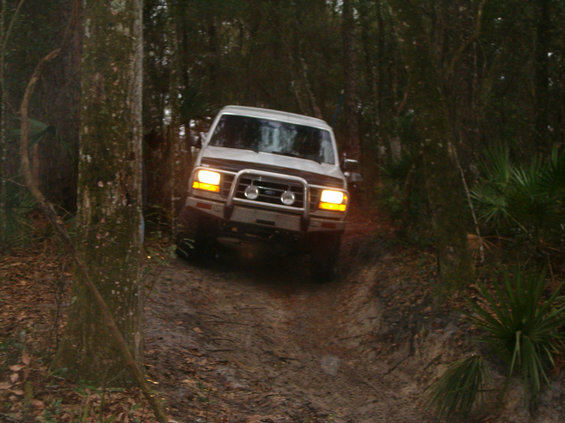 1992 Ford Bronco on a dirt path, front view with aftermarket bumper