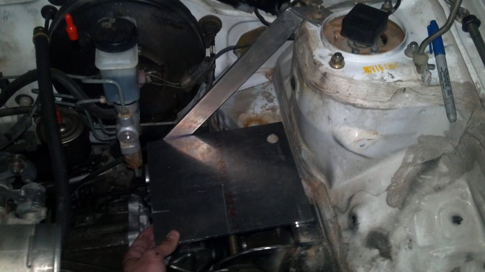 Engine bay with custom metal plate and brake fluid reservoir
