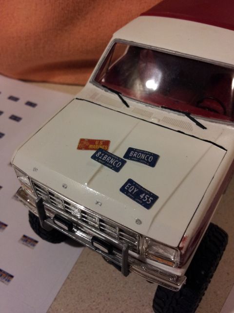 1995 Ford Bronco - Model vehicle with decorative plates on the hood, including one labeled 'BRONCO'.