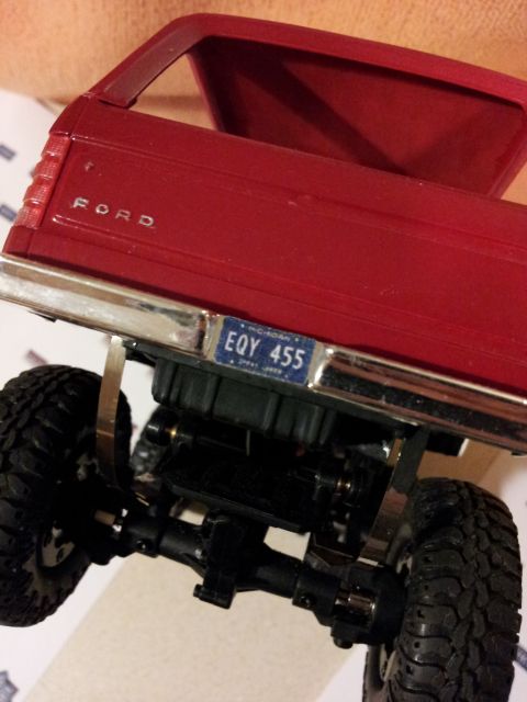 1995 Ford Bronco - Close-up rear view of a red Ford pickup truck model, showing its tailgate and license plate.
