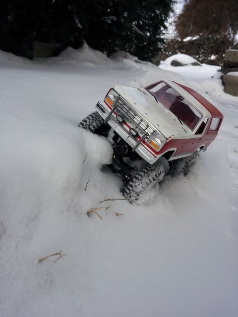 1995 Ford Bronco - RC toy truck navigates a snowy terrain, showing off its off-road capabilities.