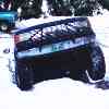 1988 Ford Bronco - A dark colored Ford Bronco is parked in a snowy area, with another vehicle visible in the background.