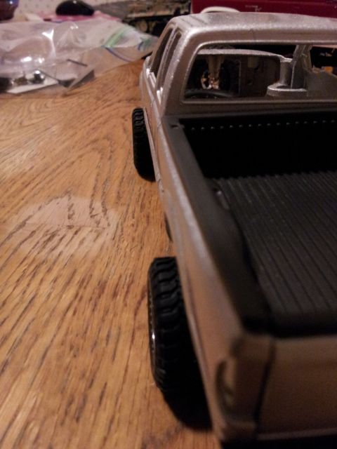 1995 Ford Bronco - A model truck is viewed from the side, resting on a wooden table.