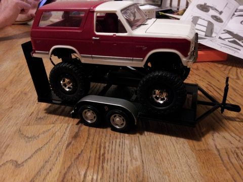 1995 Ford Bronco - Model Ford Bronco sits on a trailer, with assembly instructions visible in the background.
