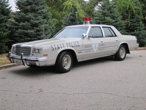1991 Ford Crown Victoria - This Rhode Island State Police car features distinctive "STATE POLICE" lettering on the front doors and a shield emblem on the rear doors.
