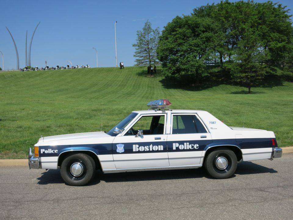 1991 Ford Crown Victoria police car, side view, white with blue stripe and 'Boston Police' text