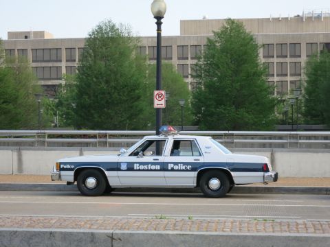 1991 Ford LTD Crown Victoria - A white 1991 Ford Crown Victoria police car with "Boston Police" text is seen from the side.