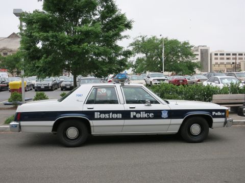 1991 Ford LTD Crown Victoria - A Boston Police car is parked in a lot with other vehicles in the background.