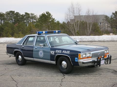 1991 Ford LTD Crown Victoria - Passenger-side front three-quarter view of a two-tone light-blue-over-dark-blue Ford LTD Crown Victoria in Massachusetts State Police liver…