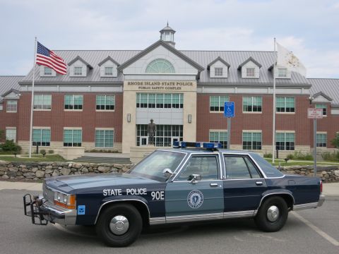 1991 Ford LTD Crown Victoria - Blue-and-silver Ford LTD Crown Victoria police sedan lettered 'STATE POLICE 90E' with a Massachusetts State Police seal on the door, parked…