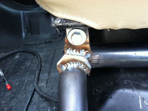 1995 Ford Bronco - A custom welded bracket is attached to the seat mount in this vehicle's interior.