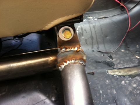 1995 Ford Bronco - Custom roll cage bracket welded to seat mounting point, showing unfinished metalwork.
