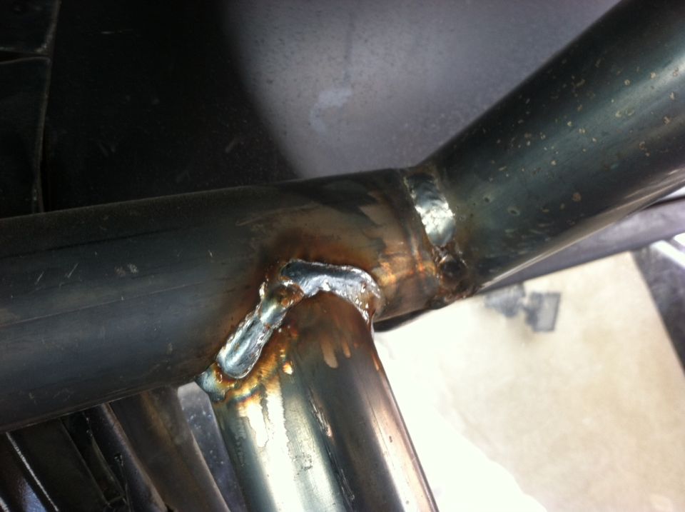 Welded metal pipes with visible weld marks and discoloration