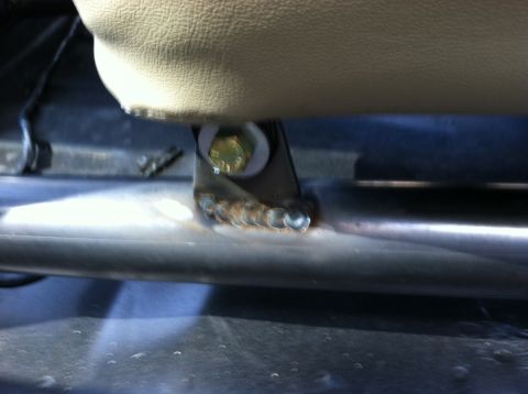 1995 Ford Bronco - Close-up view of a seat mounting bracket with visible welds and a bolt.
