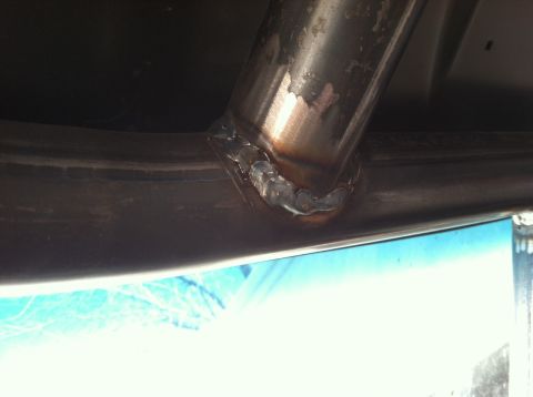 1995 Ford Bronco - A close-up view shows a freshly welded exhaust pipe, indicating a repair or modification.