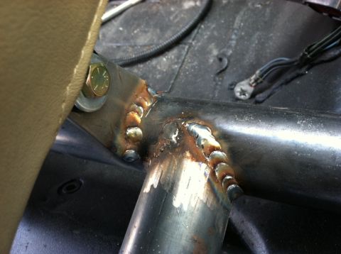 1995 Ford Bronco - Close-up view of a welded metal frame, likely part of a roll cage or structural reinforcement, visible inside a vehicle's interior.