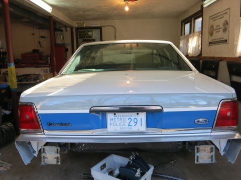 1991 Ford LTD Crown Victoria - Rear view of a 1991 Ford Crown Victoria police car, showing its distinctive taillights and license plate.