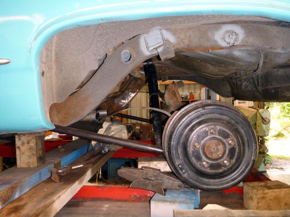 1964 Mercury Monterey rear suspension with drum brake assembly, teal body, on lift