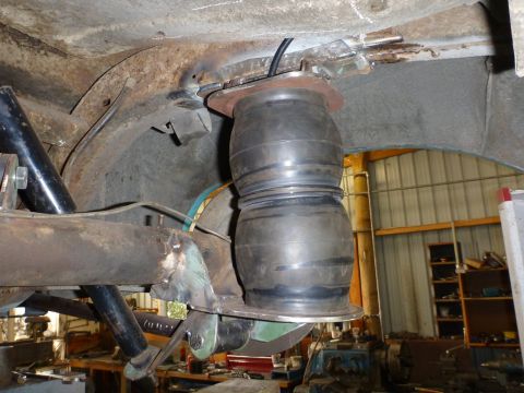 1964 Mercury Monterey - Aftermarket air suspension bag installed on the rear axle of a vehicle, showing a custom modification.