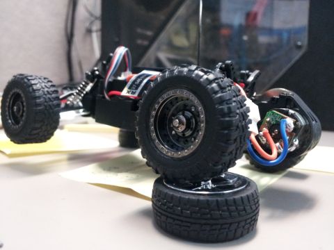 1995 Ford Bronco - This is a close-up of a remote control car's chassis, showing its suspension and drive components.