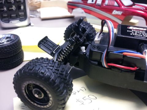 1995 Ford Bronco - Close-up of a remote control car chassis, showing its internal components and suspension system.