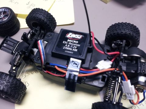 1995 Ford Bronco - Close-up of a remote control car's chassis, showing the electronic components and suspension.