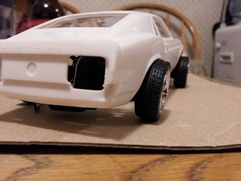 1995 Ford Bronco - Model car body, unpainted, with visible interior and chrome wheels.