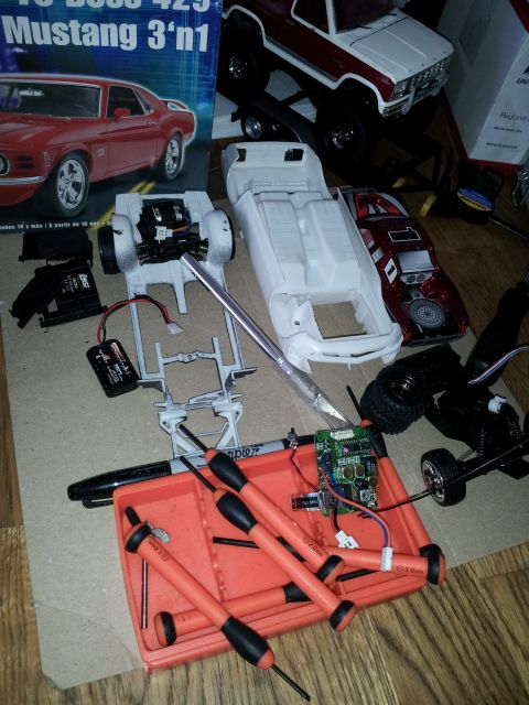 1995 Ford Bronco - Various model car parts and tools are laid out, suggesting a hobbyist's project in progress.