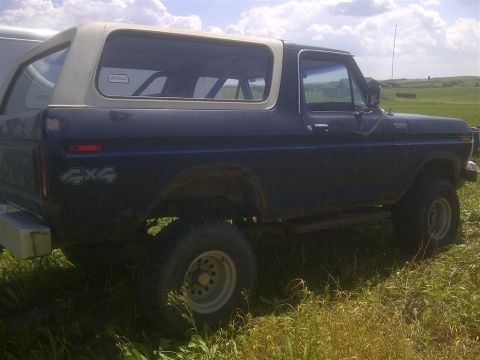 1979 Ford Bronco - This Bronco has a two-tone paint scheme and a prominent 4x4 decal on the rear quarter panel.