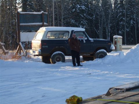 1979 Ford Bronco - Ford Bronco parked in a snowy landscape with a man standing beside it.