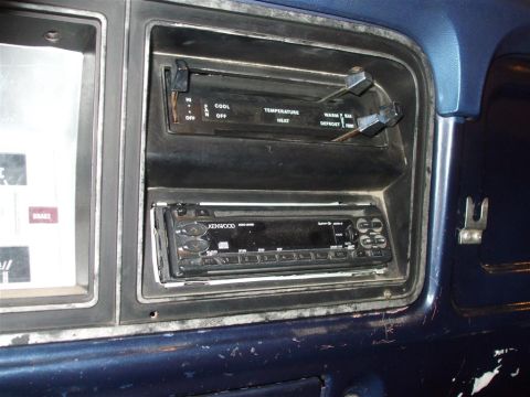 1979 Ford Bronco - Close-up of a car's dashboard, focusing on the aftermarket stereo and original climate controls.