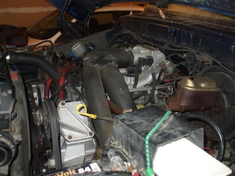 1979 Ford Bronco - Close-up view of an engine bay, showing various mechanical parts and wiring.
