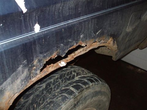 1979 Ford Bronco - Severe rust has eaten away at the wheel well of this vehicle, showing significant deterioration.