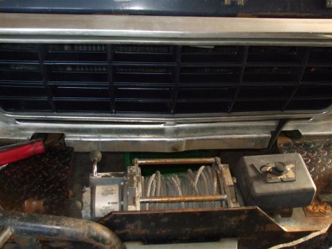 1979 Ford Bronco - The front grille and winch of a vehicle are visible, with a label on the winch reading 'M10000'.