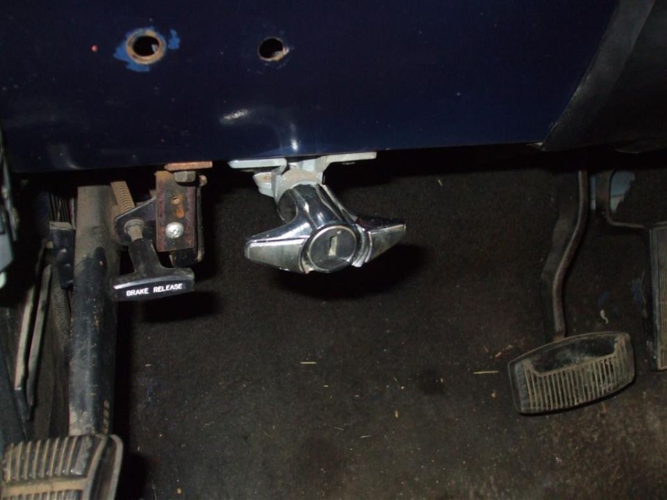 Under dash view of brake release lever and ignition switch