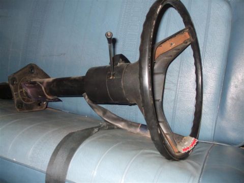 1979 Ford Bronco - A steering column and wheel are shown resting on a blue seat, with a Supermotors.net watermark visible.