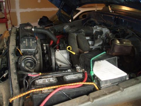 1979 Ford Bronco - The engine bay of a vehicle is shown with various components and wiring.
