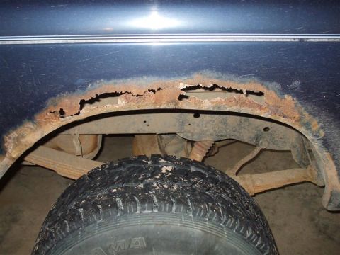1979 Ford Bronco - Significant rust damage is visible on the wheel well of this vehicle, obscuring its model year.