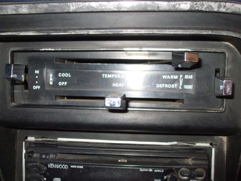 1979 Ford Bronco - Close-up of vehicle's dashboard climate controls and aftermarket stereo system.