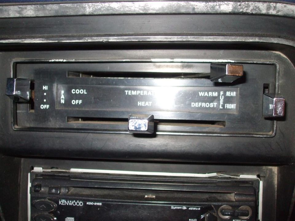 Interior view of climate controls and Kenwood stereo in a vehicle