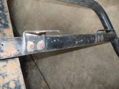1979 Ford Bronco - Close-up of a rusty metal frame component with bolted brackets, likely from a vehicle.