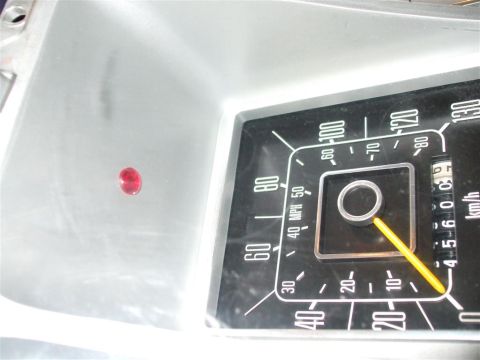 1979 Ford Bronco - Close-up of the 1979 Ford Bronco's interior dashboard gauge cluster, showing the speedometer and a red indicator light.