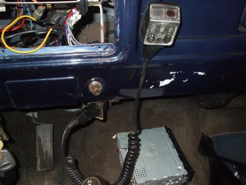 1979 Ford Bronco - Aftermarket stereo and CB radio installation visible in the interior of a dark blue vehicle.