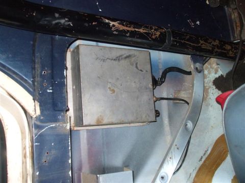 1979 Ford Bronco - Close-up view of an interior component, possibly an electronic control unit, mounted within the vehicle's structure.