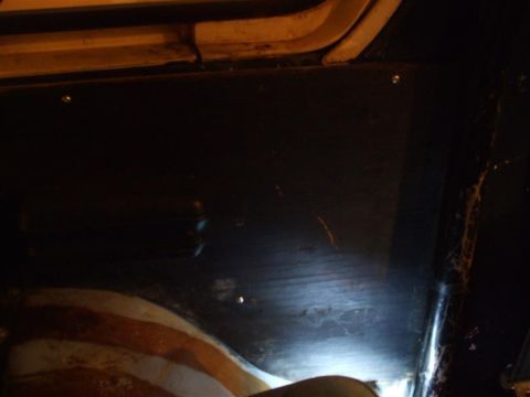 1979 Ford Bronco - Close-up view of an interior panel, showing screws and a portion of a seat.