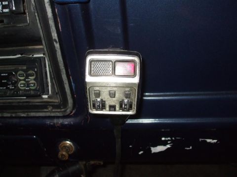 1979 Ford Bronco - Close-up of a CB radio and car stereo inside a vehicle.