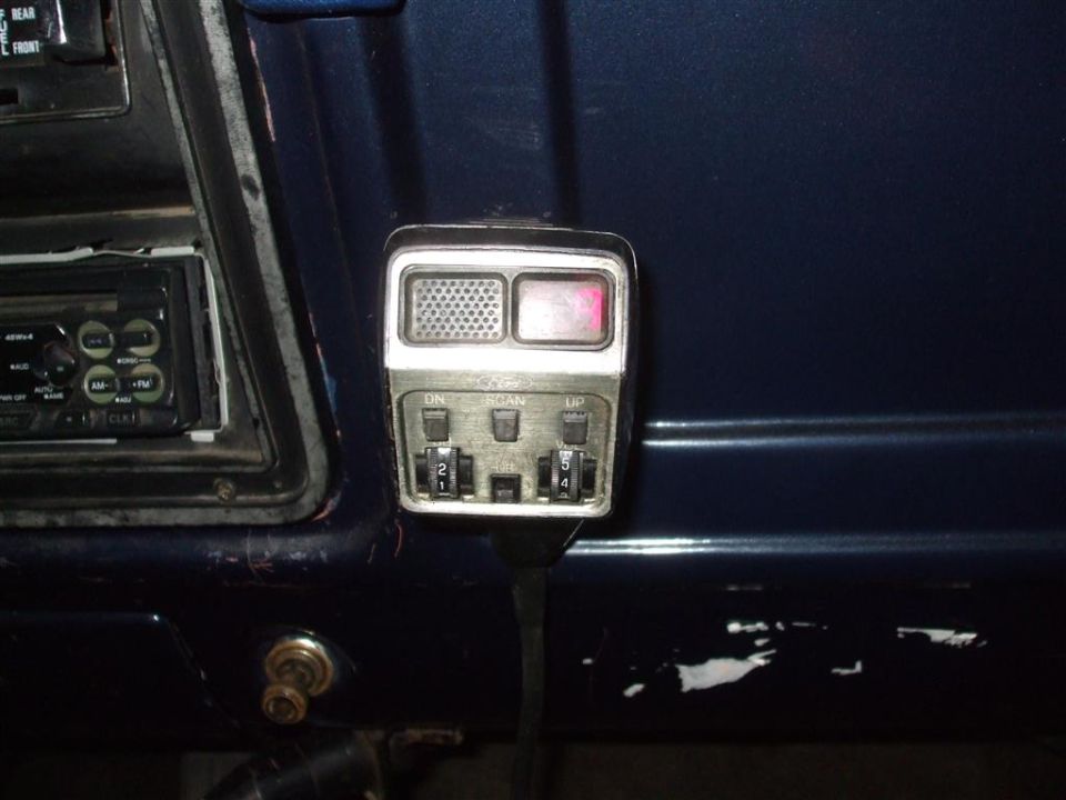 Dark blue interior with a CB radio and car stereo visible