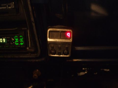 1979 Ford Bronco - Interior view of a dashboard a green digital radio display and a red digital gauge showing the number 9.