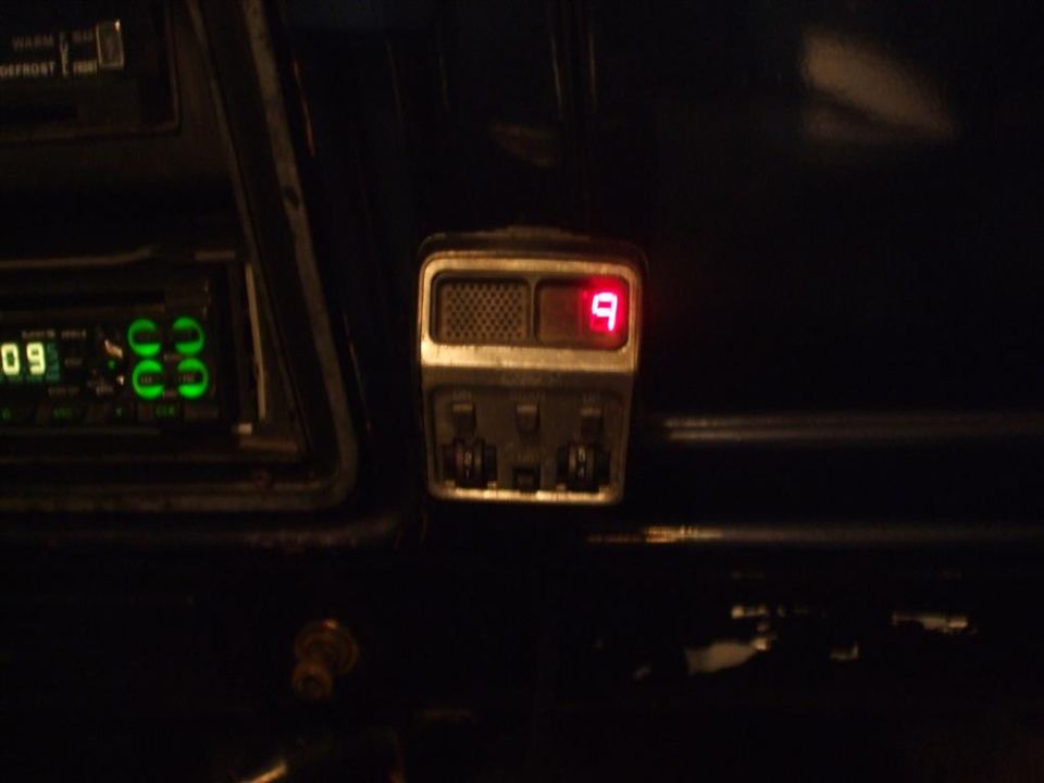 Dashboard with green digital radio display and red digital gauge showing '9'