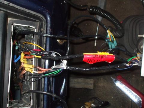 1979 Ford Bronco - Close-up of a vehicle's interior wiring, showing a red label with text.